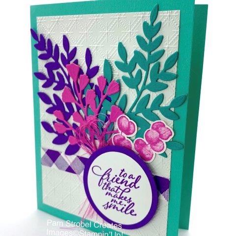 A pop of bright colors are featured using Stampin'Up's Forever Fern stamp set and dies. Create a fun Buffalo Check stamped strip placing it on the diagonal pattern.. Bermuda Bay, Gorgeous Grape and Magenta Madness colors. Add fun details like the shredded Magenta Madness ribbon for soft and touchable texture as well as the Dianty Diamonds white background. Enjoy more Fern inspiration here : https://www.pamstrobelcreates.com/forever-fern-stamp-set